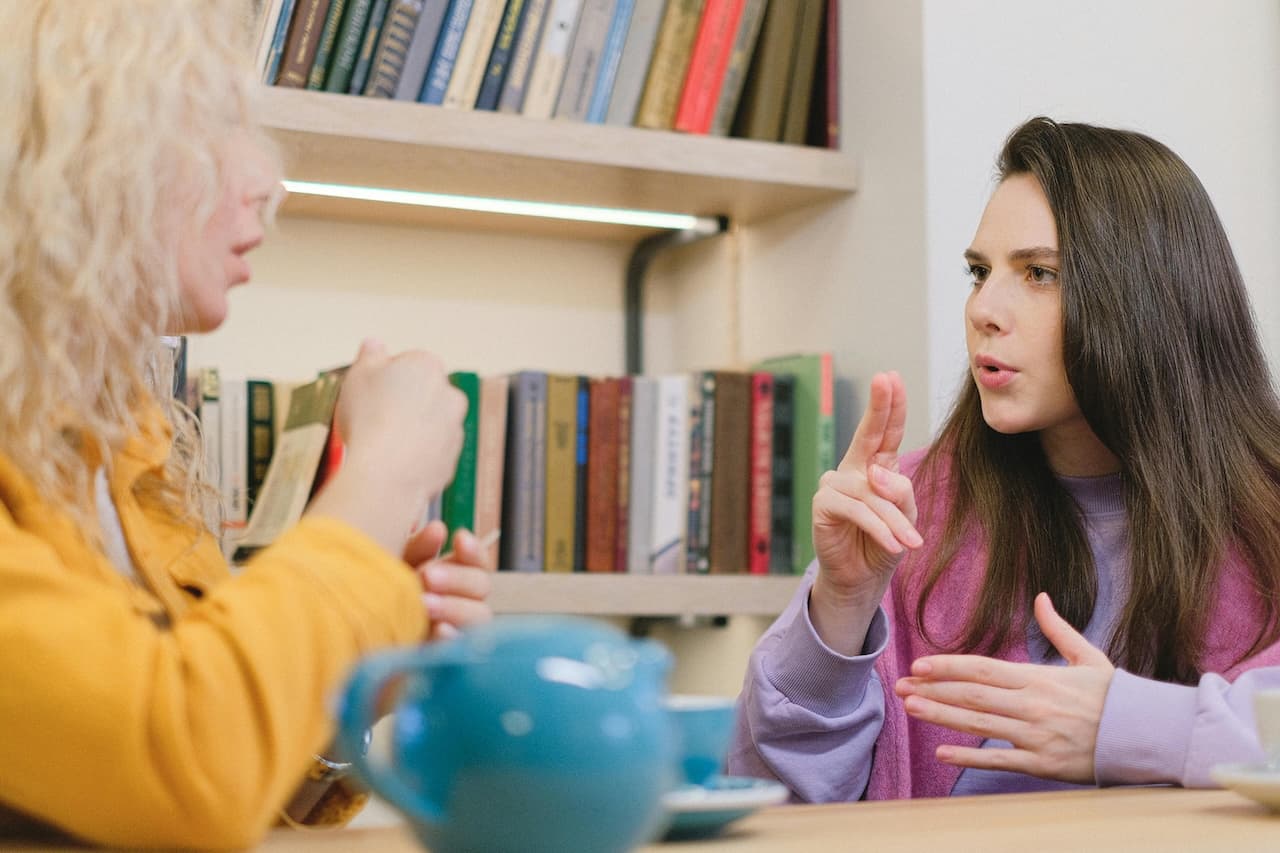 Photo by SHVETS production: https://www.pexels.com/photo/deaf-mute-friends-in-university-library-7516574/