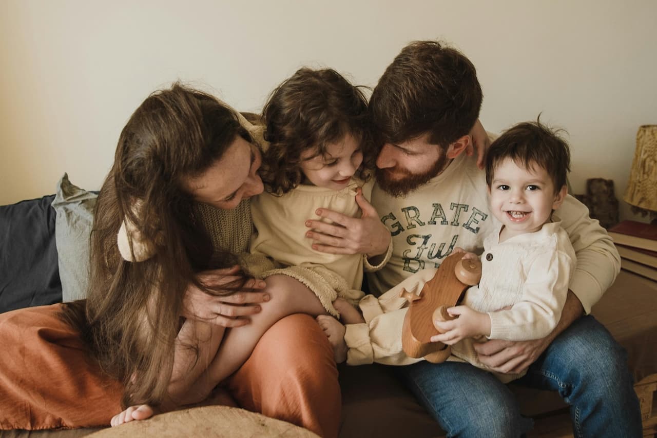 Photo by Arina Krasnikova: https://www.pexels.com/photo/a-happy-couple-with-young-children-5103411/