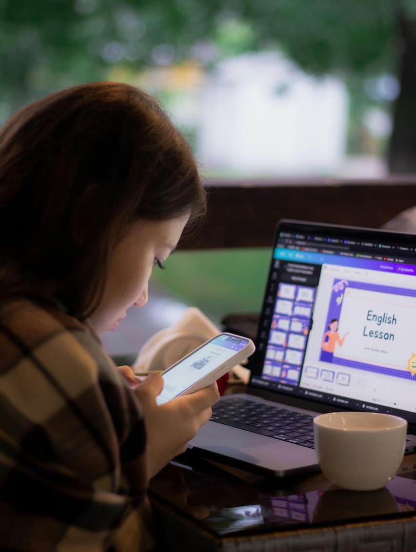 Photo by Kenzhar Sharap: https://www.pexels.com/photo/woman-using-cellphone-near-laptop-17653299/